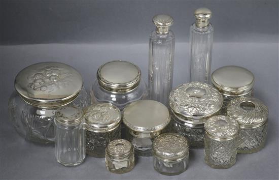 Thirteen assorted silver topped toilet jars, of varying shapes and sizes including Reynolds Angels and engine turned.